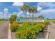 Entrance to Bay Vista Blvd, a deed-restricted community, with bright landscaping and American flag at 1040 Caples St, Englewood, FL 34223