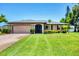 Charming single-story home with a manicured lawn, mature landscaping, and a convenient two-car garage at 1040 Caples St, Englewood, FL 34223