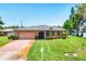 Lovely residence with a well-manicured lawn, mature landscaping, and a practical two-car garage at 1040 Caples St, Englewood, FL 34223