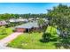 Charming single-story home with a spacious lawn, mature palm trees, and a convenient driveway at 1040 Caples St, Englewood, FL 34223