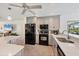 This kitchen features black appliances and gray cabinetry with ample counter space for cooking at 1040 Caples St, Englewood, FL 34223