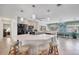 An open kitchen features an island countertop with bar stool seating, plus black appliances and ample lighting at 1040 Caples St, Englewood, FL 34223