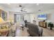 Bright living room with tile floors, comfortable seating, and a large television for relaxing and entertaining at 1040 Caples St, Englewood, FL 34223