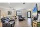 Cozy living room featuring comfortable seating, a ceiling fan, and a large television for entertainment at 1040 Caples St, Englewood, FL 34223