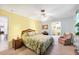 Comfortable bedroom features a tropical-themed bedspread, musical instruments, and access to additional rooms at 1040 Caples St, Englewood, FL 34223