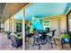 Spacious covered patio with comfortable seating, dining table and view of the backyard at 1040 Caples St, Englewood, FL 34223