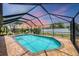 Beautiful pool with screen enclosure is set against a sky with colorful clouds at 1040 Caples St, Englewood, FL 34223