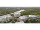 Aerial view of the apartments, surrounding trees, and river at 10521 Amberjack Way # 303, Englewood, FL 34224