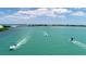 Beautiful aerial view of boats cruising on the clear turquoise water near a bridge at 10521 Amberjack Way # 303, Englewood, FL 34224