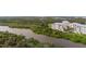 Aerial view of the community and river, showcasing waterfront living and lush surroundings at 10521 Amberjack Way # 303, Englewood, FL 34224