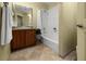 Well-lit bathroom with a vanity, granite countertop, and shower-tub combo at 10521 Amberjack Way # 303, Englewood, FL 34224