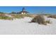 Beachfront view of a house with a widow's walk overlooking the sandy dunes at 10521 Amberjack Way # 303, Englewood, FL 34224
