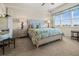 Bright bedroom with a bed, large window, and views of the neighborhood at 10521 Amberjack Way # 303, Englewood, FL 34224