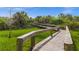 Wooden boardwalk winding through lush greenery, inviting residents to explore nature at 10521 Amberjack Way # 303, Englewood, FL 34224