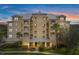 Condominium complex with balconies and a well-maintained landscape, promising a luxurious living experience at 10521 Amberjack Way # 303, Englewood, FL 34224