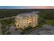 Stunning condominium complex featuring multiple stories, a metal roof, and serene waterfront views at 10521 Amberjack Way # 303, Englewood, FL 34224