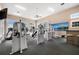 Well-equipped fitness center with various weight machines, treadmills, and ample natural light at 10521 Amberjack Way # 303, Englewood, FL 34224