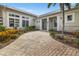 Inviting front entrance with a stone walkway, lush landscaping, and a covered porch at 10521 Amberjack Way # 303, Englewood, FL 34224