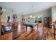 Spacious game room featuring a pool table, seating area, wood paneling, and charming nautical decor at 10521 Amberjack Way # 303, Englewood, FL 34224