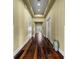 Long hallway with hardwood floors, recessed lighting, and neutral color scheme at 10521 Amberjack Way # 303, Englewood, FL 34224