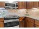 Kitchen with stainless steel oven, range, and microwave at 10521 Amberjack Way # 303, Englewood, FL 34224