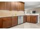 Gourmet kitchen features stainless steel appliances, granite countertops, wood cabinets and tile floors at 10521 Amberjack Way # 303, Englewood, FL 34224