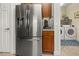 Kitchen with stainless steel refrigerator and view to the laundry room at 10521 Amberjack Way # 303, Englewood, FL 34224