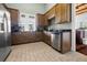 Well-equipped kitchen with stainless steel appliances, wood cabinets, and tiled floor at 10521 Amberjack Way # 303, Englewood, FL 34224