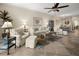 Open living area with tile flooring, ceiling fan, comfortable furniture, and view into the dining area at 10521 Amberjack Way # 303, Englewood, FL 34224