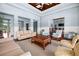 Interior lobby featuring an open floorplan, hardwood floors, and large windows with views of the outside at 10521 Amberjack Way # 303, Englewood, FL 34224