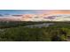 Scenic view of a waterway winding through lush greenery beneath a vibrant sunset sky at 10521 Amberjack Way # 303, Englewood, FL 34224