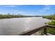 Scenic view of a calm river surrounded by lush vegetation, showcasing natural beauty at 10521 Amberjack Way # 303, Englewood, FL 34224