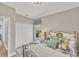 This is a cozy bedroom featuring beach themed pillows, a decorative rug, and a white closet at 124 Cutlass Dr, Rotonda West, FL 33947