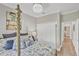 Bedroom featuring white closet doors, wood flooring, decorative pillows, and decorative light fixture at 124 Cutlass Dr, Rotonda West, FL 33947