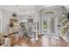 Bright foyer showcasing hardwood floors, elegant decor, and natural light from the front doors at 124 Cutlass Dr, Rotonda West, FL 33947