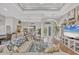 Bright and spacious living room with open layout, hardwood floors, and a stylish, neutral color palette at 124 Cutlass Dr, Rotonda West, FL 33947
