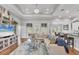 Inviting living room featuring hardwood floors, tray ceiling, modern decor, and ample seating at 124 Cutlass Dr, Rotonda West, FL 33947