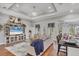 Open-concept living room featuring hardwood floors, tray ceiling, modern decor, and natural light at 124 Cutlass Dr, Rotonda West, FL 33947