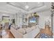 Elegant living room featuring hardwood floors, tray ceiling, modern decor, and a comfortable sectional at 124 Cutlass Dr, Rotonda West, FL 33947
