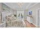 Elegant main bedroom with tray ceiling, decorative artwork and glass door access to pool at 124 Cutlass Dr, Rotonda West, FL 33947