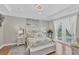 Charming main bedroom with tray ceiling, decorative painting, and glass door access at 124 Cutlass Dr, Rotonda West, FL 33947