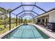 This beautiful screened-in pool has a hot tub and lounge area with views of the Florida landscape at 124 Cutlass Dr, Rotonda West, FL 33947