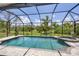 The beautiful pool features a screened enclosure and a stunning view of the natural Florida landscape at 124 Cutlass Dr, Rotonda West, FL 33947