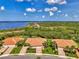 Beautiful aerial view of several homes with terra cotta roofs situated near lush greenery and a scenic waterway at 13051 Creekside Ln, Port Charlotte, FL 33953