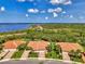 Beautiful aerial view of a home with terra cotta roof situated near lush greenery and a scenic waterway at 13051 Creekside Ln, Port Charlotte, FL 33953