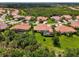 Beautiful aerial view of the community featuring lush landscaping, tile roofs, and serene surroundings at 13051 Creekside Ln, Port Charlotte, FL 33953