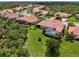 Aerial view showcases the houses' screened patios, manicured lawns, and tropical landscaping at 13051 Creekside Ln, Port Charlotte, FL 33953