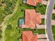 Overhead view of house with a screened-in pool, lush lawn, and tropical landscaping, with nearby houses at 13051 Creekside Ln, Port Charlotte, FL 33953