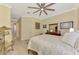 Spacious bedroom with a large bed, a ceiling fan, and a view into the hallway with a dresser at 13051 Creekside Ln, Port Charlotte, FL 33953