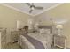 Comfortable bedroom with a ceiling fan, nautical decorations, and a beach-themed color palette at 13051 Creekside Ln, Port Charlotte, FL 33953